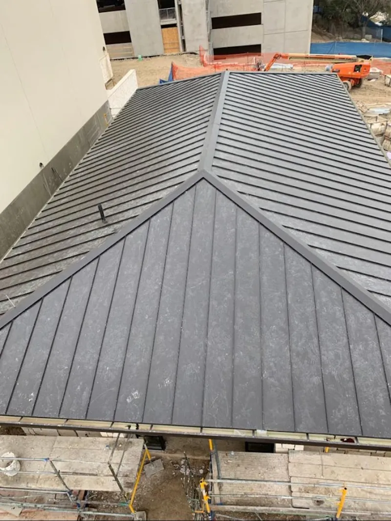 Commercial metal roof construction with crane equipment in Berea