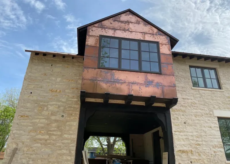 Copper metal panel facade on a stone building for Skylight Installation in Berea
